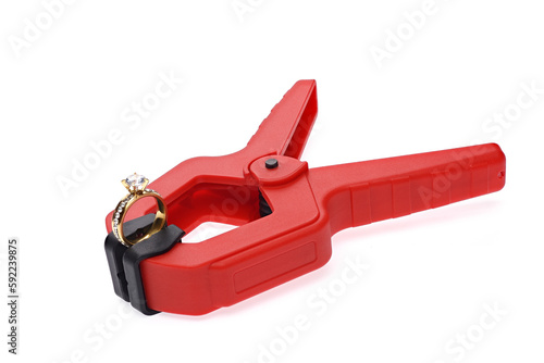 Canvas Print The gemstone ring is clamped in a red plastic clamp