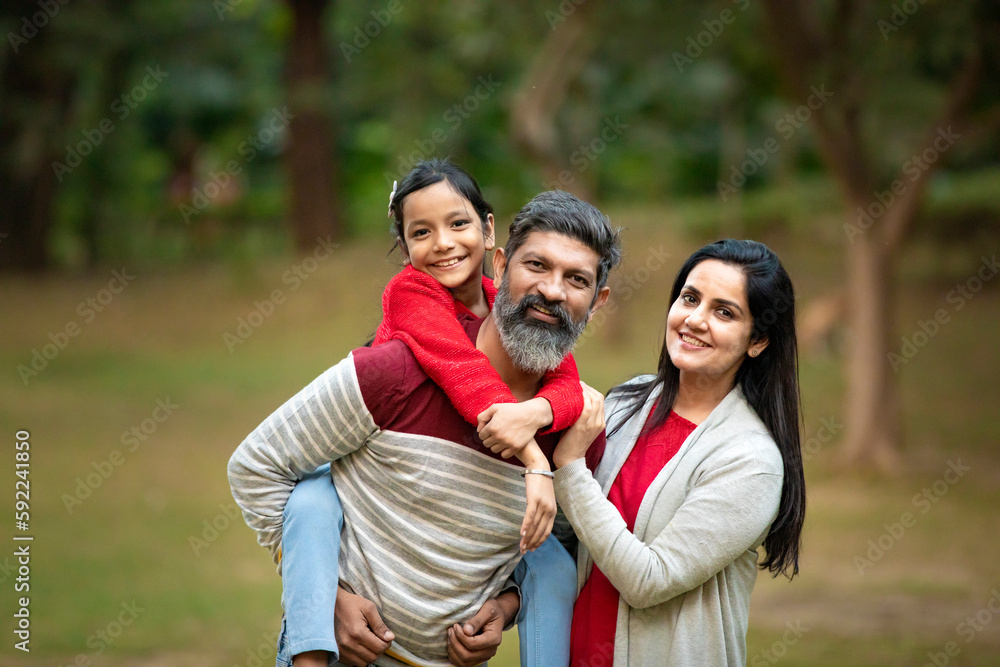 Happy indian couple with his little girl at garden. Stock Photo | Adobe ...