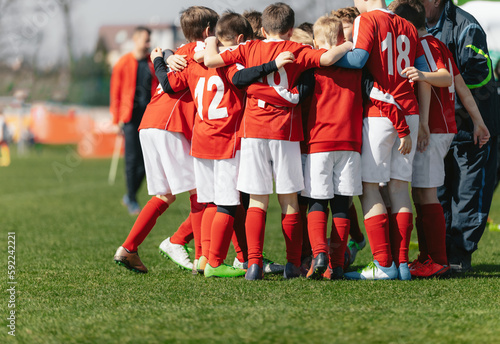 Youth Team Huddle. Sports Players in a Team Meeting With Coach at Soccer Match Half Time Break. Coaching Junior Level European Football Players