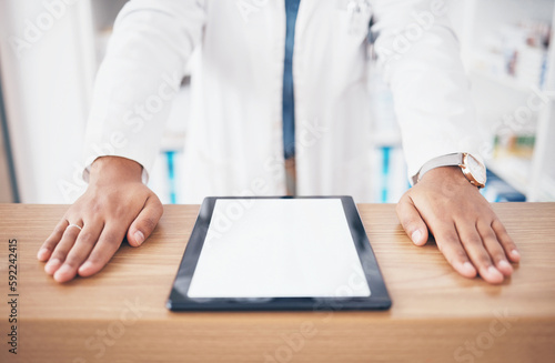 Tablet, mockup or hands of woman pharmacist on table ready to help with healthcare services. Marketing space, screen or closeup of doctor by desk counter with medicine online research in drugstore