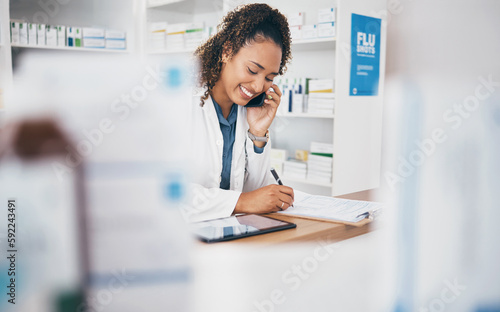 Phone call, pharmacist or woman in pharmacy writing with smile in customer services or healthcare clinic. Help desk, welcome or happy doctor speaking, consulting or talking in medication on drugstore photo