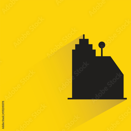 condo tower with shadow on yellow background