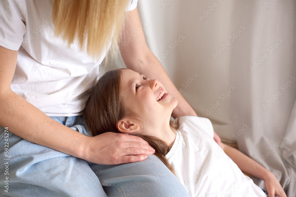 mom and preteen daughter talking. child daughter lying on her mother's lap. Time together, women's generation, International Women's Day, Happy Mother's Day. mom and preteen daughter talking. child daughter lying on her mother's lap. Time together, women's generation, International Women's Day, Happy Mother's Day.