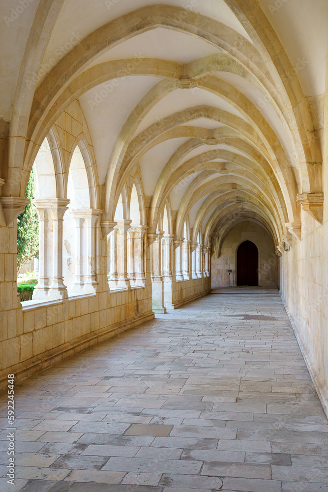 monestary corridors with arches and paved walkways