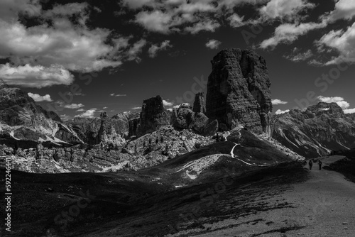 Scenic grayscale of rocky Dolomitic Mountains in Italy with a cloudscape in the background