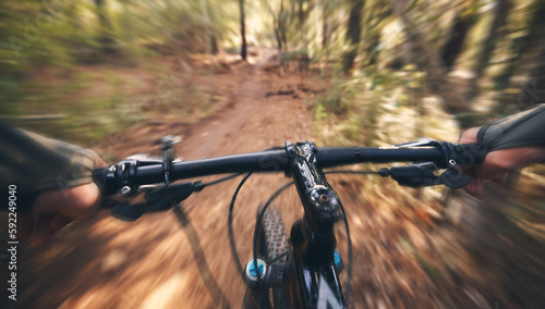 POV, mountain bike and person cycling in forest, park and path for adventure, speed and motion blur. Closeup perspective of bicycle handle, athlete and outdoor action in nature, off road and sports