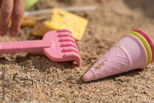 Colorful shovels on the sand at the beach