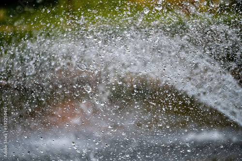 water splash with small drops in fountain  abstract natural background  selective focus