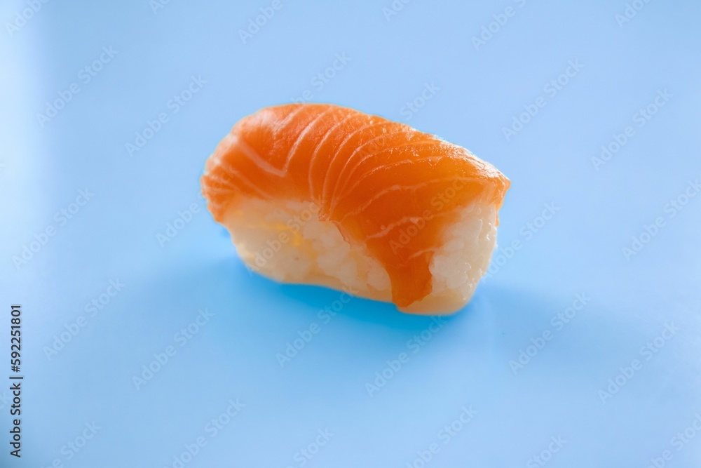 Salmon sushi roll isolated on a blue background Salmon sushi roll isolated on a blue background