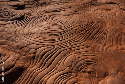 A close up of a rock with a pattern of lines in the sand AI generation