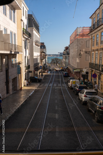 Lisbon street with tram rails and parked cars © Gustavo Palacios