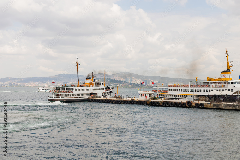 Ships near pier with princess islands and Istanbul at background in Turkey.