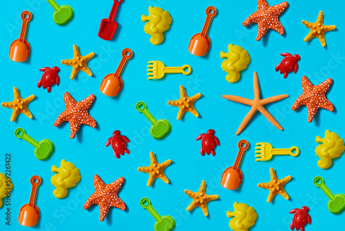 beach toys and starfish on a blue background