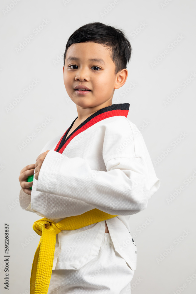 Portrait Asian boy kid karate martial arts. Taekwondo uniform with yellow belt. Asian school boy isolated on white background banner Portrait Asian boy kid karate martial arts. Taekwondo uniform with yellow belt. Asian school boy isolated on white background banner