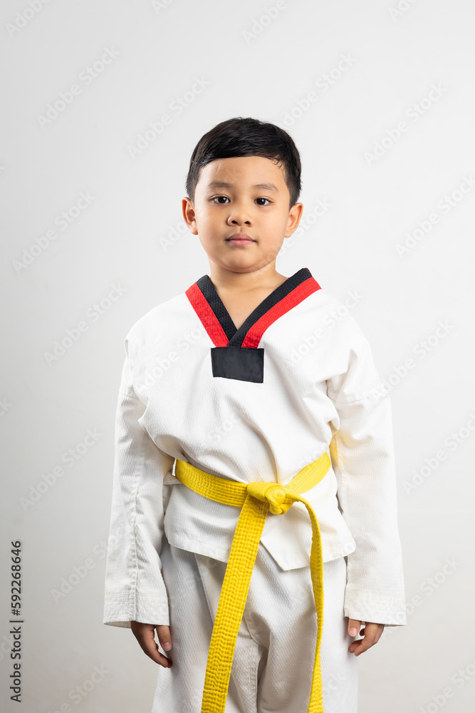 Portrait Asian boy kid karate martial arts. Taekwondo uniform with yellow belt. Asian school boy isolated on white background banner Portrait Asian boy kid karate martial arts. Taekwondo uniform with yellow belt. Asian school boy isolated on white background banner