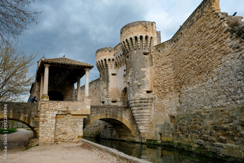March 18, 2023. Pernes-les-Fontaines, Provence-Alpes-Côte d'Azur, France. Fortified city gates and a bridge over the Nesque river. Porte Notre-Dame. Notre-Dame-des-Grâces chapel.