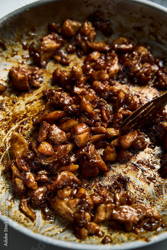 Chicken Tocino. Chicken in gooey sweet glaze in the wok. Caramelized chicken thighs in sweet sauce