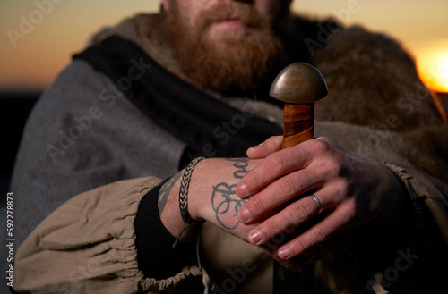 man with sword sunset