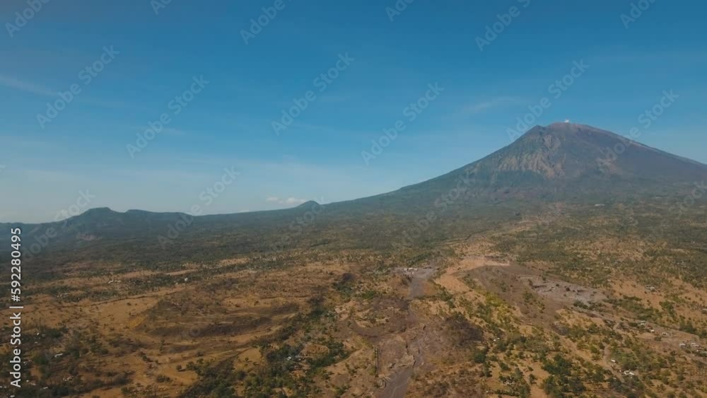 Aerial view volcano Agung and mountains against the blue sky, volcanic, mountain landscape, Bali, Indonesia. Conical volcano of Gunung Agung. 4K, Aerial footage. Aerial view volcano Agung and mountains against the blue sky, volcanic, mountain landscape, Bali, Indonesia. Conical volcano of Gunung Agung. 4K, Aerial footage.