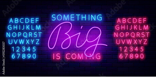 Something big is coming neon badge on brick wall. Special offer label. Vector stock illustration