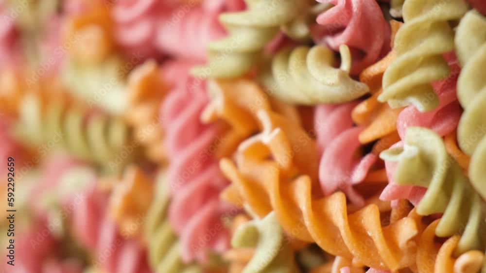 Rice vegetable pasta in the form of spirals, top view. Healthy rice pasta with tomatoes, celery, carrots and beets Rice vegetable pasta in the form of spirals, top view. Healthy rice pasta with tomatoes, celery, carrots and beets