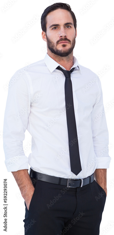 Unsmiling businessman standing with hands in pockets Unsmiling businessman standing with hands in pockets