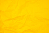 The abstract background from crumpled yellow paper texture.