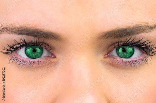 Bright green eyes on pretty female face