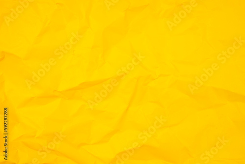 The abstract background from crumpled yellow paper texture.