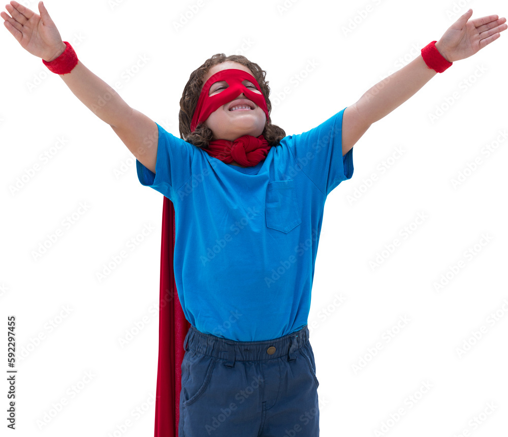 Boy standing with arms outstretched wearing cape