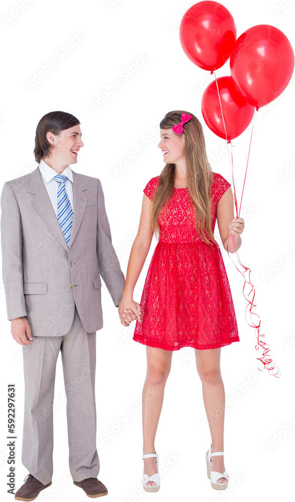 Smiling geeky couple standing hand in hand Smiling geeky couple standing hand in hand