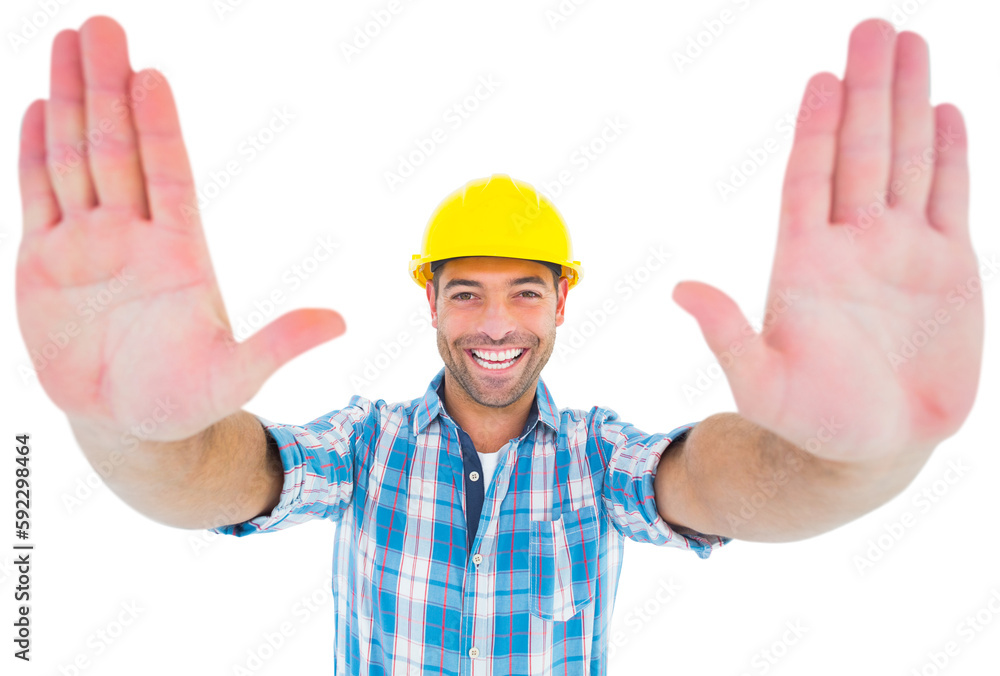 Smiling manual worker gesturing stop sign