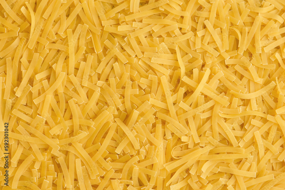Yellow background with raw vermicelli noodles. Concept - pasta as background. Yellow background with raw vermicelli noodles. Concept - pasta as background.