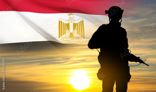Silhouette of soldier against the sunset with Egypt flag. Background for National Holidays. Concept - Armed Forces. EPS10 vector