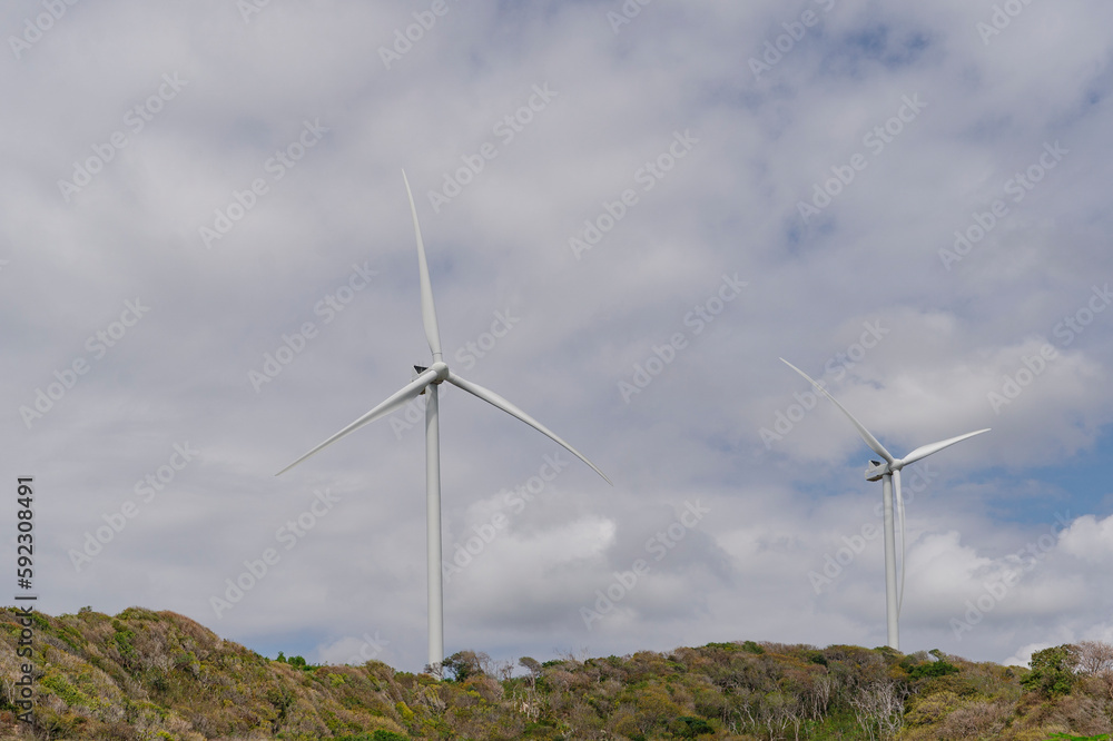Panoramic view of a wind farm or wind farm with tall wind turbines to generate electricity. Green energy concept. Panoramic view of a wind farm or wind farm with tall wind turbines to generate electricity. Green energy concept.