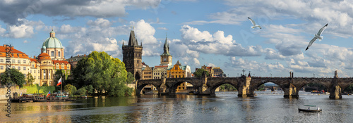 Panoramic landscape of the Old Town of Prague with view of Charles Bridge and Gothic Towers with spires. Wide panorama of Praga historic downtown, Great Medieval Charles Bridge and Vltava River. photo