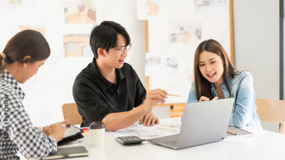 Construction design concept, Architects team is look house plan on laptop to discussing together Construction design concept, Architects team is look house plan on laptop to discussing together