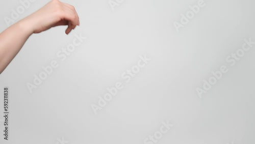 Close up shot of a woman's hand making a flick gesture. 4k, slow motion.