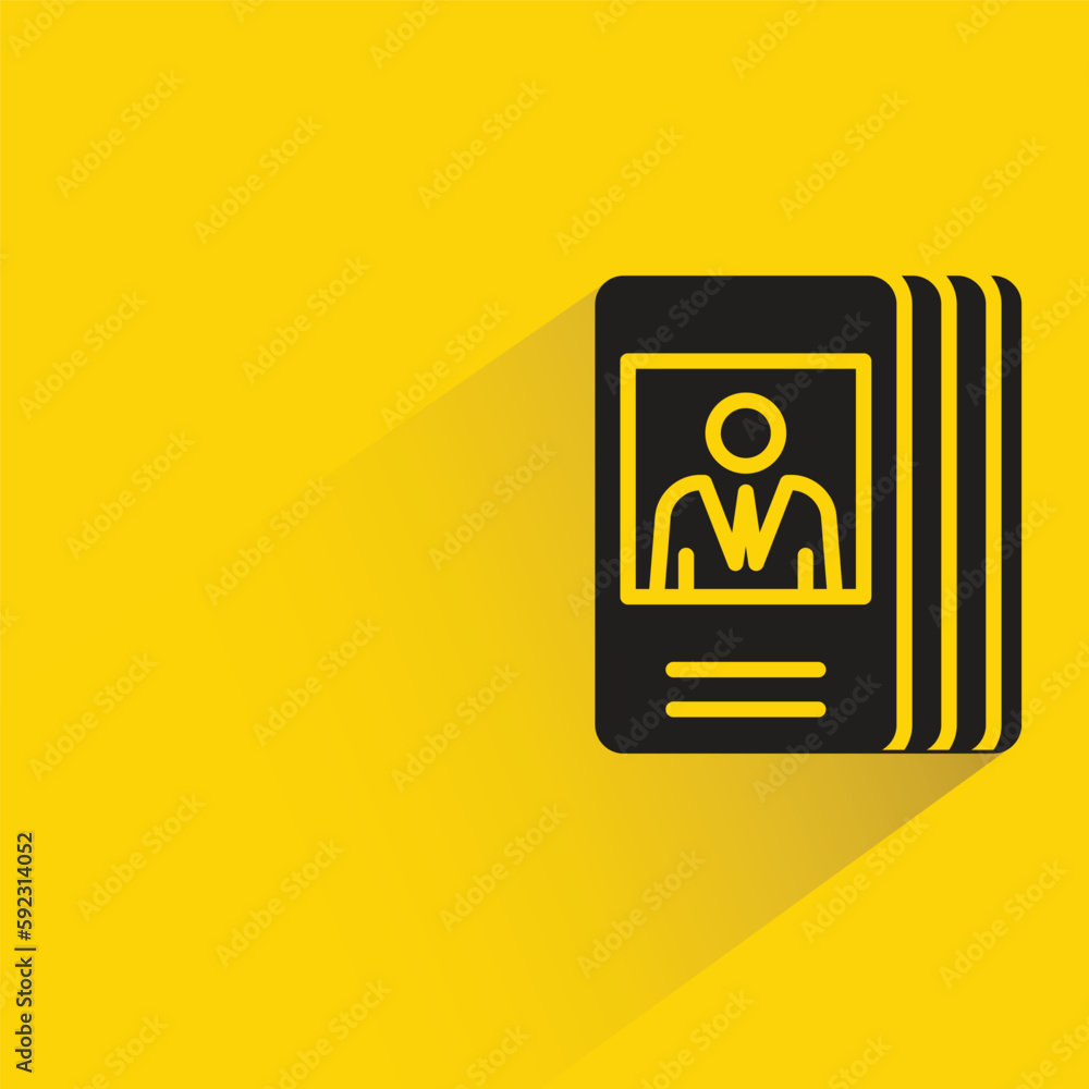 stack of business cards with shadow on yellow background stack of business cards with shadow on yellow background