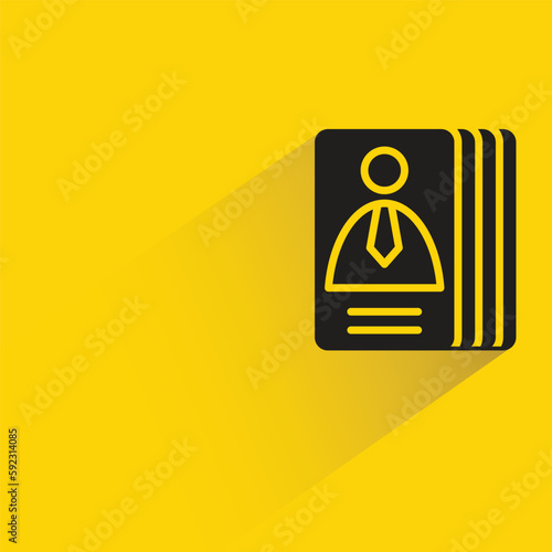 stack of business cards with shadow on yellow background