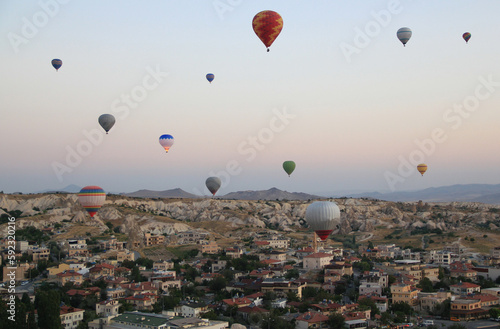Flight of hot air balloons at dawn over a valley in Cappadocia (Turkey) near the town of Goreme 