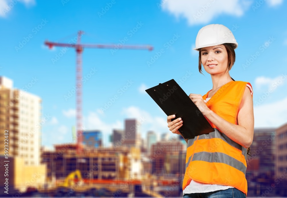 Happy young construction worker with on site outside. Happy young construction worker with on site outside.