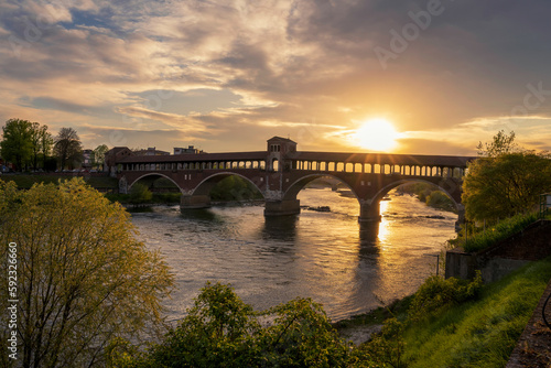 Ponte Coperto (covered bridge) over Ticino river in Pavia at sunny, Lombardy, italy.