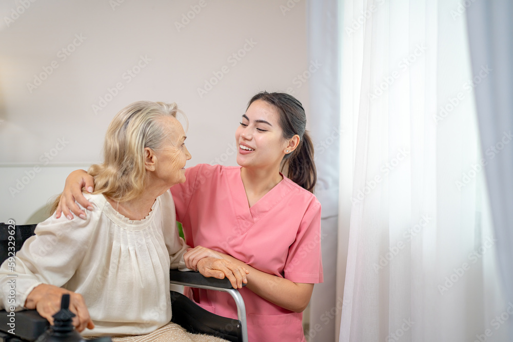 Elderly woman and nurse at home. Healthcare worker girl cares about senior female person indoors