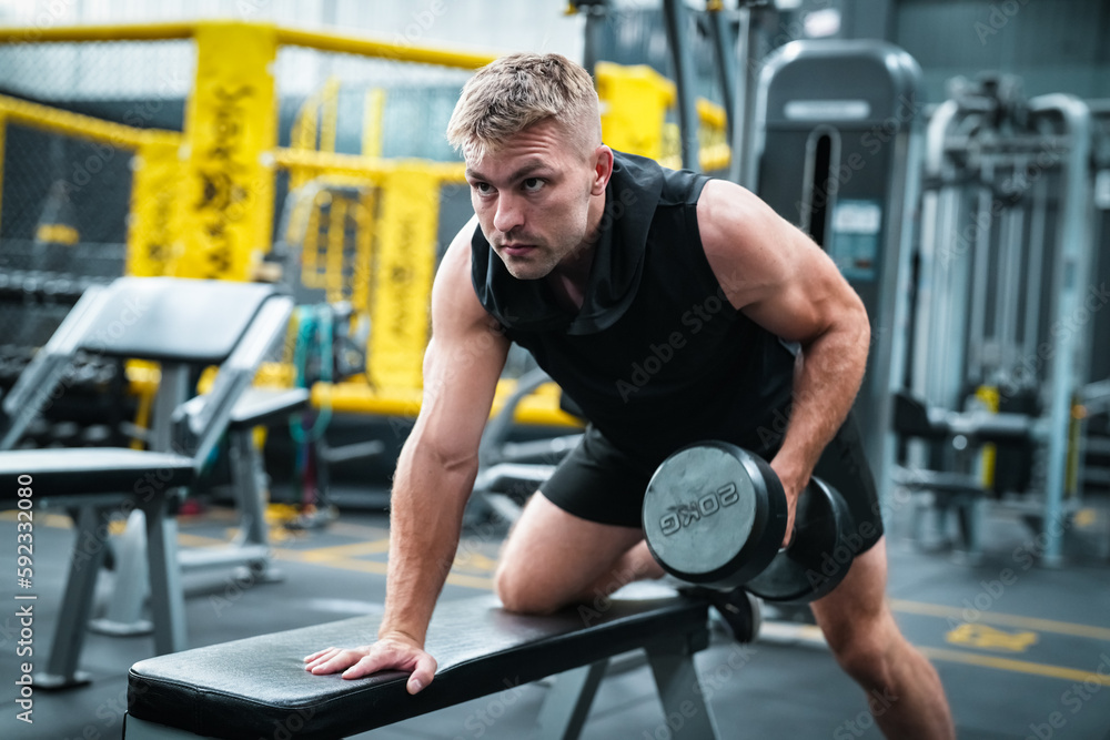 Male athlete exercising in the gym, lifting weights, pulling joints. Male athlete exercising in the gym, lifting weights, pulling joints.