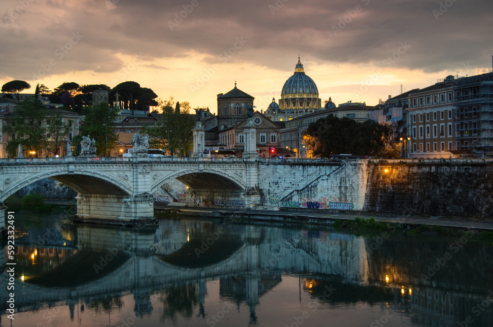 sunset on Tiber river and Ponte Vittorio Emanuele II toward Saint Peter's cathedral 