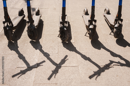 Electric scooters are parked in the city center. Modern public mobile transport