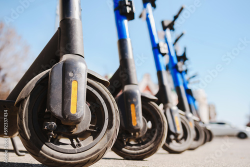 Electric scooters are parked in the city center. Modern public mobile transport
