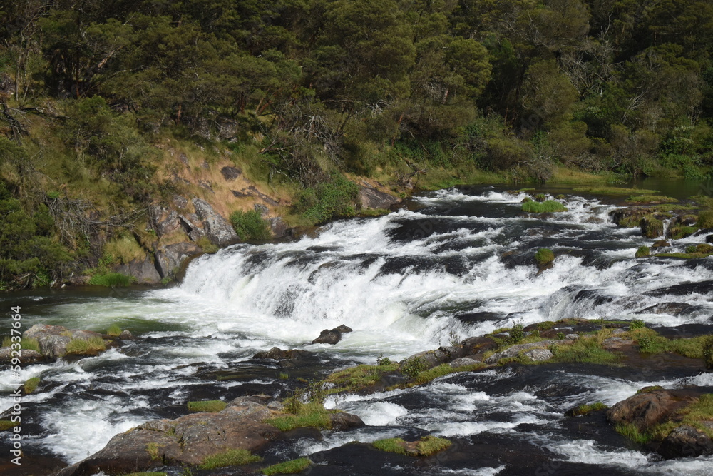 River flowing with green hills and blue sky River flowing with green hills and blue sky