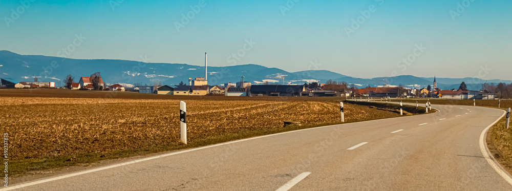 Winter landscape on a sunny day with a sugar factory near Plattling, Deggendorf, Bavaria, Germany